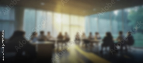 Blurry out of focus dark modern office interior with sunset light, warm business background banner