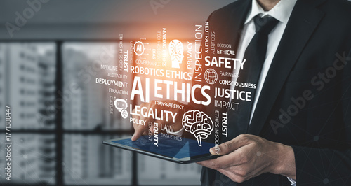 Foto A business professional stands with a tablet, surrounded by terms related to AI ethics and regulations