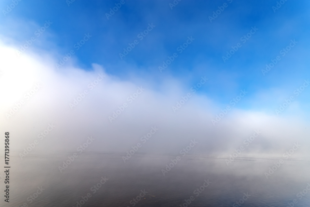Obraz premium Fog over the water in the sunny autumn day