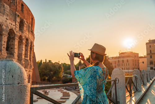 Photography 08 08 2025 Rome, Italy - Traveler photographing Colosseum during sunset