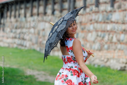 Woman in Floral Dress with Lace Parasol Outdoors