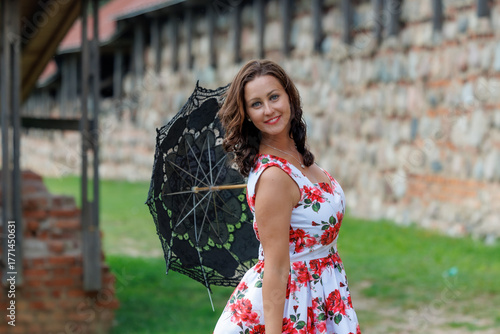 Woman in Floral Dress with Lace Parasol Outdoors