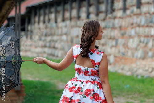 Woman in Floral Dress with Lace Parasol Outdoors