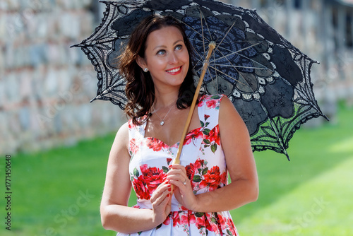 Woman in Floral Dress with Lace Parasol Outdoors