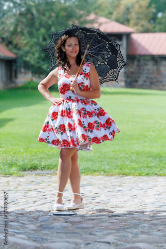 Woman in Floral Dress with Lace Parasol Outdoors