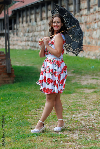 Woman in Floral Dress with Lace Parasol Outdoors