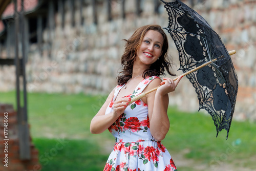 Woman in Floral Dress with Lace Parasol Outdoors