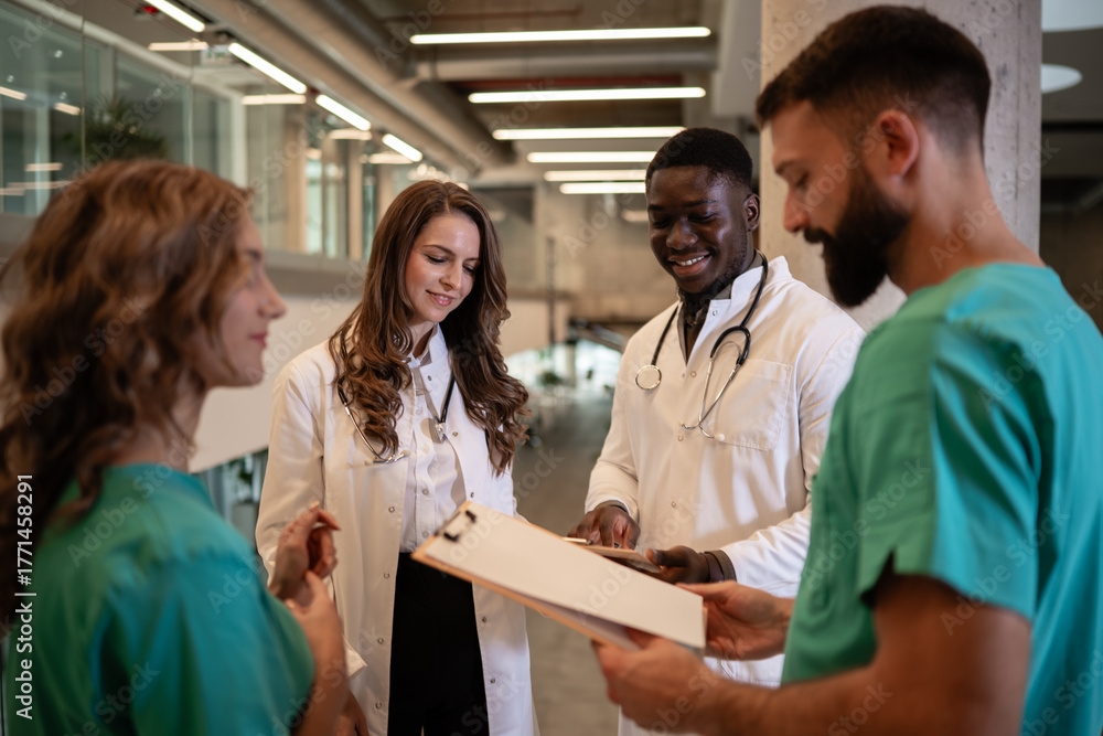 Fototapeta premium Diverse medical team collaborating on patient charts