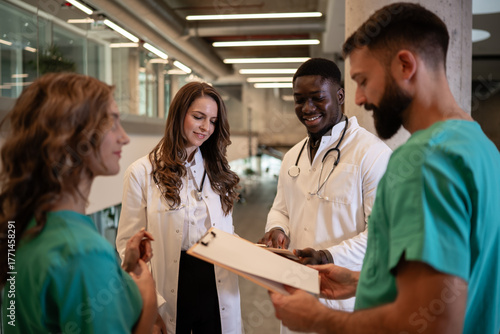 Diverse medical team collaborating on patient charts