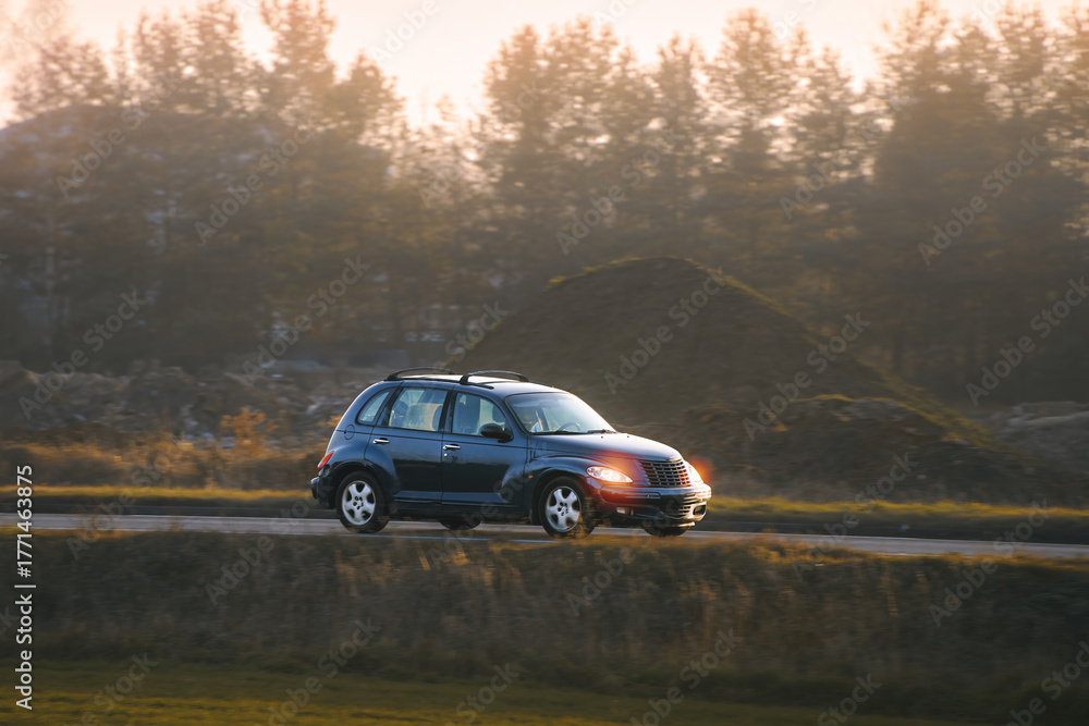 Fototapeta premium Modern car driving through scenic surroundings