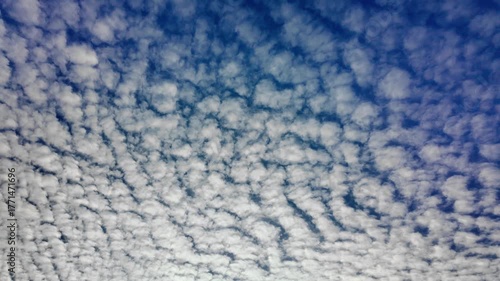 Altocumulus clouds on bright blue sky in autumn sky