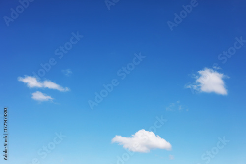 Blue sky background and white clouds soft focus, and copy space horizontal shape.