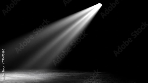 Dramatic spotlight beam illuminating empty stage dark background