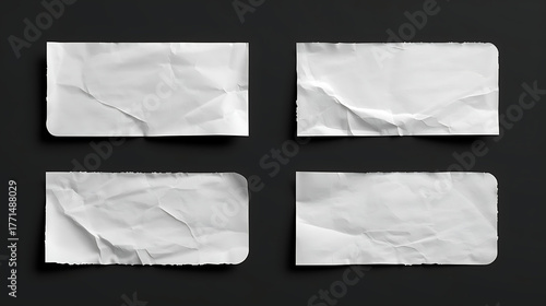 A set of four blank white rectangular paper stickers with realistic textures is presented against a solid black background. Each sticker features unique folds, rounded corners.