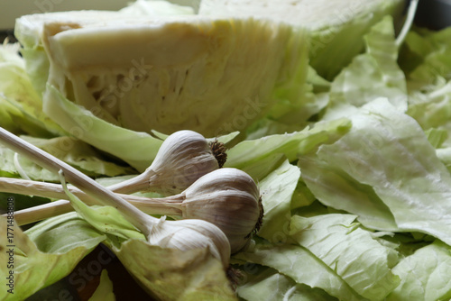 Autumn is harvest time: garlic on cut cabbage heads, close-up
