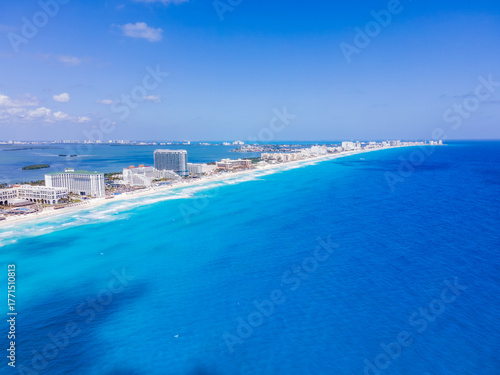 Wallpaper Mural Aerial view of turquoise waters meeting the pale sands and towering hotels of Cancun's Hotel Zone under a bright sky, Cancun, Mexico. Torontodigital.ca