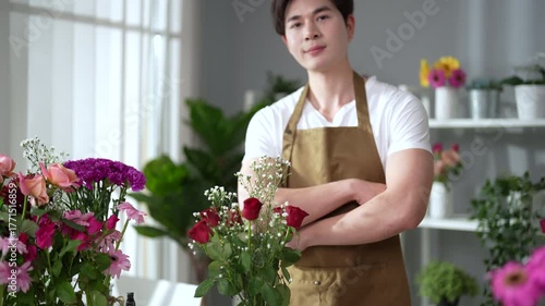 Asian employee works in a beautiful flower shop.