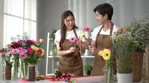 Asian employee works in a beautiful flower shop.