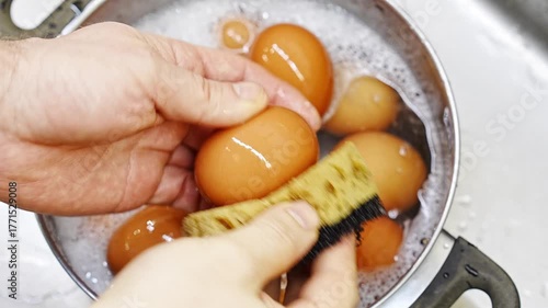 Chicken eggs are washed with soapy water and a sponge. hygiene for the prevention of intestinal diseases.