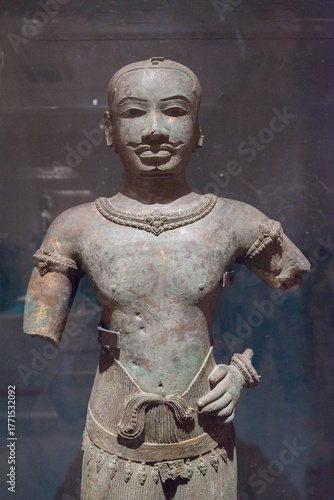Chinese ancient bronze statuette in a museum, closeup of photo