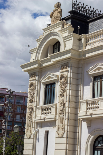 A facade with statues and arches on an ancient building in Valencia