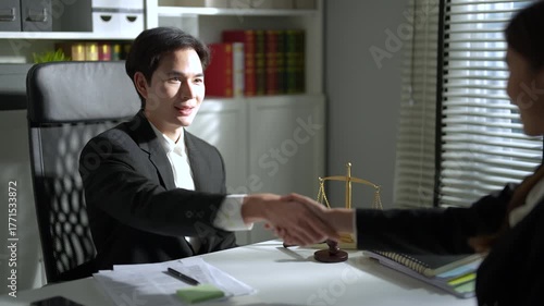 Business people shake hands when reaching a business agreement together.