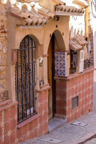 narrow street with house facade and design on brick wall in the house