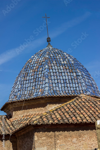 the tiled roof is brown and the tower is blue
