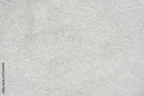 A full-frame, uniform close-up of a light gray suede or nubuck leather texture with a soft, slightly rough nap