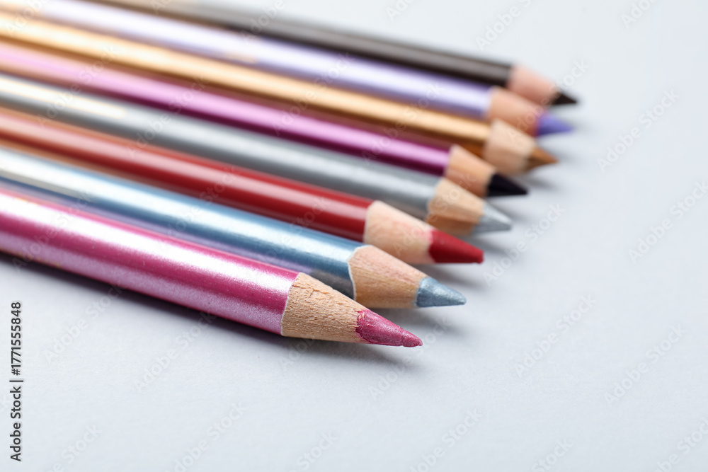 Naklejka premium Different eye pencils on light background, closeup