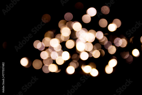 Abstract bokeh lights on a dark background. Christmas magical light, overlay or lens flare effect