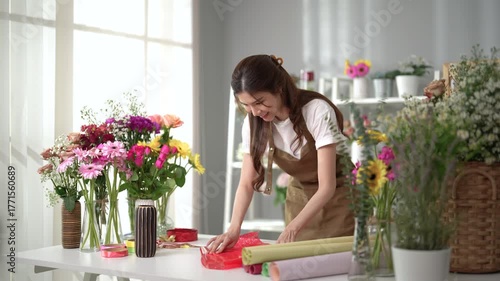 Asian employee works in a beautiful flower shop.