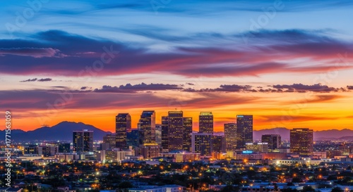 Panoramic view of Phoenix city skyline against a vibrant sunset sky filled with dynamic clouds
