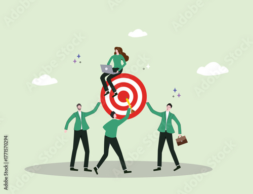 A team collaborates to hold up a target as one member marks the center, symbolizing coordination, teamwork, leadership, and strategy highlighting that true success comes from collective effort.