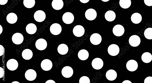 A black backdrop speckled with numerous, randomly placed white circular shapes