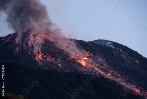 Принти на полотні Powerful night eruption with flowing lava, sparks, and heavy smoke from the crater of Stromboli volcano, Sicily, Italy