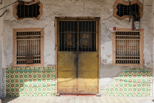 Old shophouse facade with vintage Peranakan tiles in George Town, Penang, Malaysia.
