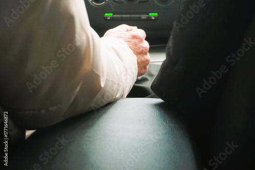 Rückenansicht von altem Ehepaar mit weißem und schwarzem Mantel beim Autofahren am Nachmittag im Herbst