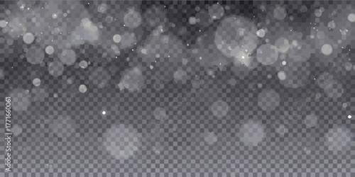 Softly falling snow particles and bokeh lights on a transparent dark background