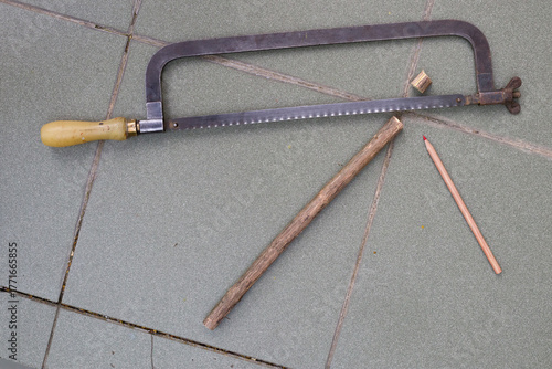 Still life with a saw and pencil.