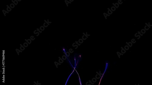Glowing blue and purple electrical wires against a black background
