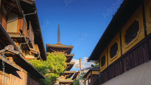 Kyoto, Japan - Oct 11 2024, Panoramic view of Yasaka Pagoda of Hōkan-ji Temple, building facades and trees in the foreground, in the evening, Kyoto, Japan