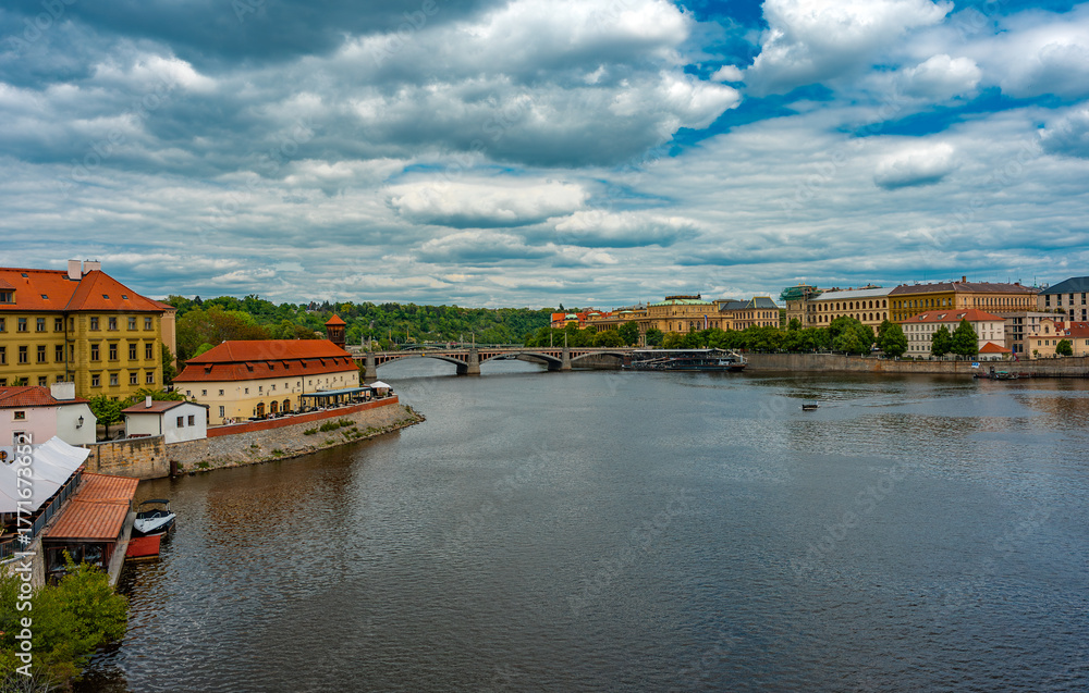 Fototapeta premium Vltava River Flowing Through Historic Prague Cityscape.