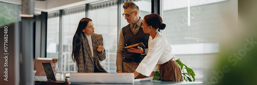 A diverse group of professionals actively participating in discussion and collaboration at a modern workspace