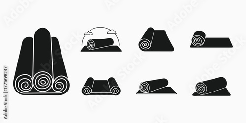 Collection of rolled and unrolled yoga mats for fitness and exercise