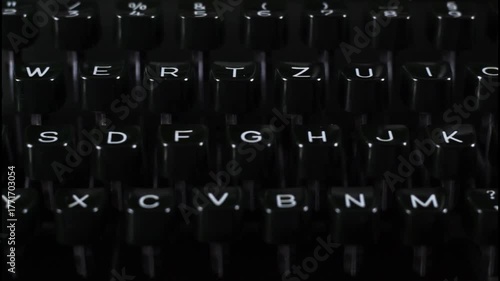 vintage type writer machine - dark keys - tracking horizontally - illustrates gothic ideas, dark novella writing or similar