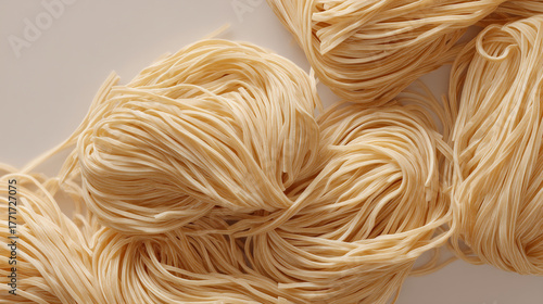 Close up view of several bundles of uncooked noodles on a white surface