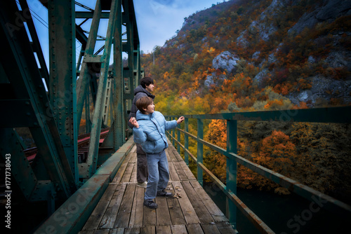 Father and son enjoying autumn view together