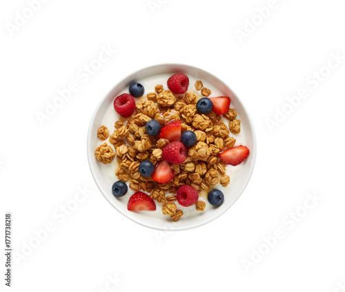 a bowl of granola topped with yogurt and berries, seen from above on a white background
