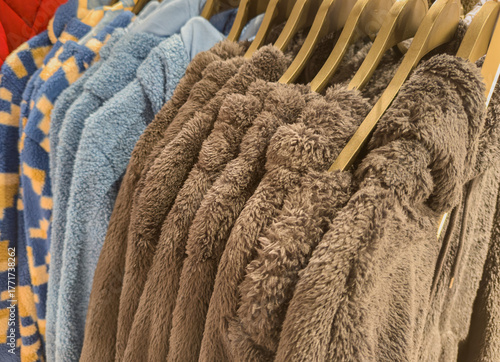 Fluffy soft teddy fleece jackets on a clothes rack in a department store 